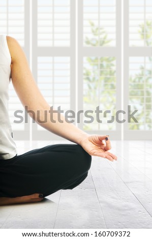Yoga seria: woman in lotus yoga position making ohm mudra gesture