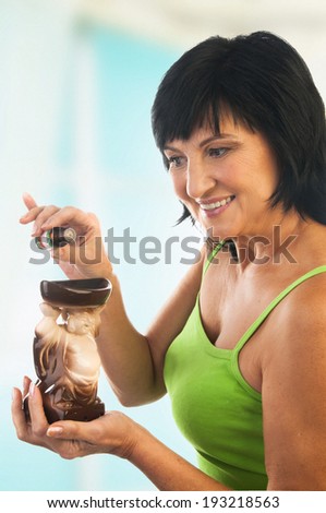 Mature woman dripping oil into the aromatherapy oil burner