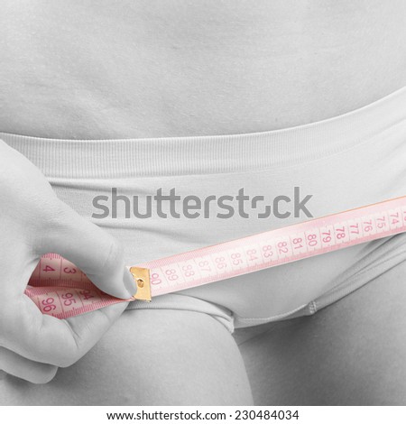 Black and white image of woman measuring shape of perfect hips close up