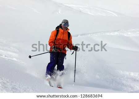 Rugged man cruising through powder snow.
