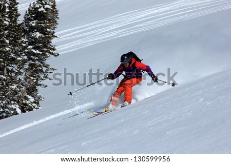 Woman extreme skiing down a slope in the Utah Mountains, USA.