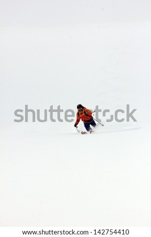 Skier in fresh powder snow with a white snow background, Utah, USA.