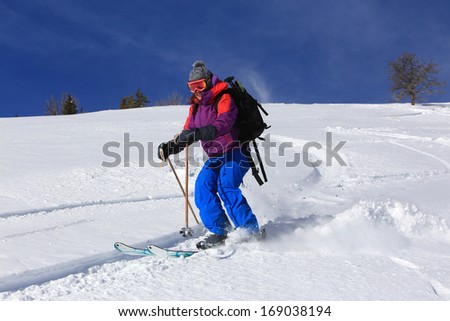 A woman skiing in fresh powder snow, Utah, USA.
