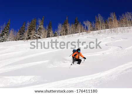 Rugged man skiing down a steep slope, Utah, USA.