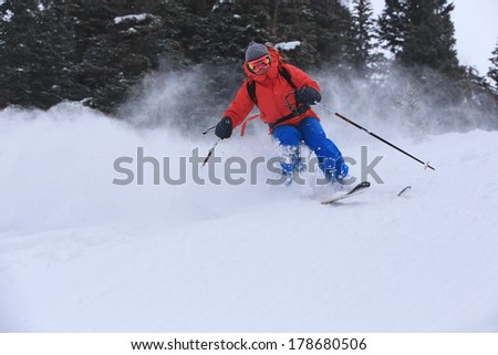 A woman skiing deep powder snow during a winter snow storm, Utah, USA.