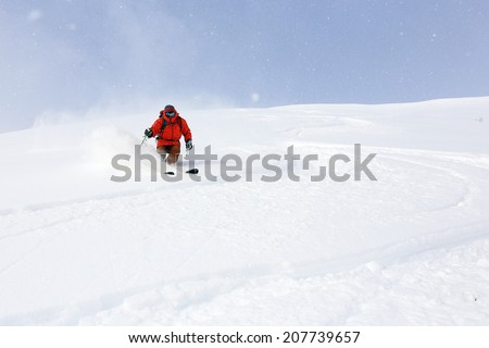 Active man skiing fresh powder snow in the Utah mountains, USA.