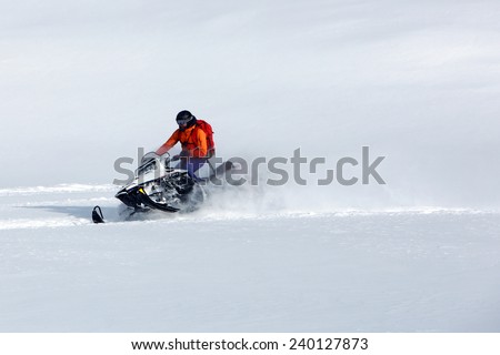Man snowmobile riding in the Utah mountains, USA.