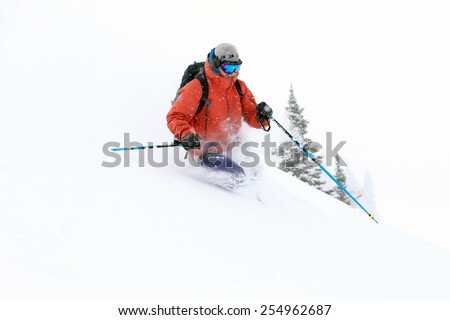 Winter scene with a man skiing powder, Utah, USA.