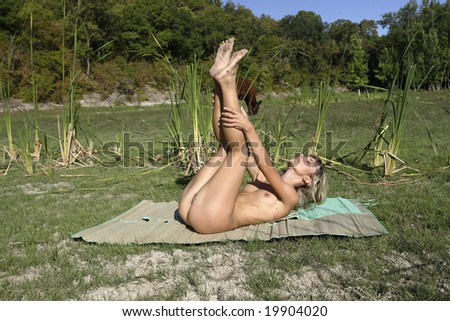 stock photo Beautiful nude girl on a pasture