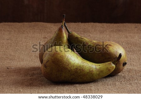 Three pears lie on a table. Still life.