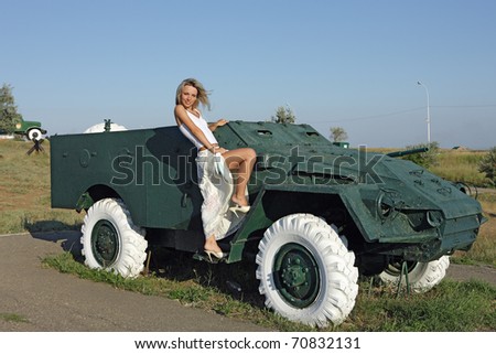 Beauty and the armored car. A young woman near sarogo armored car.