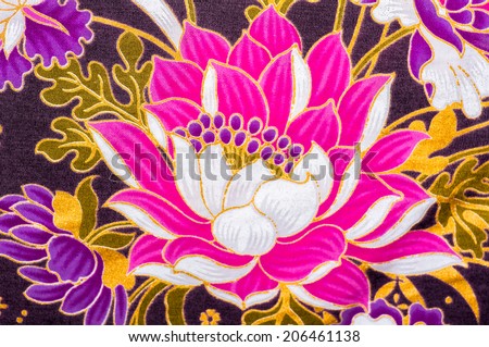 Close up lotus flower on batik sarong pattern background in Thailand