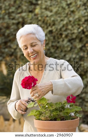 senior lady pruning her plants