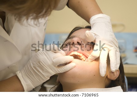 Dentist Examining Teeth