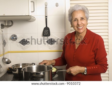Clip Art Woman Cooking. stock photo : Senior happy woman cooking at kitchen