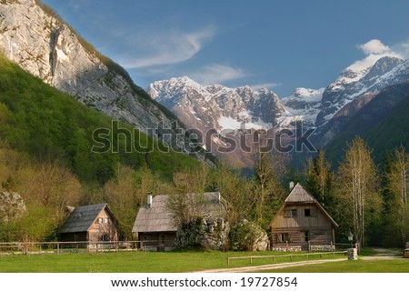 Wooden cottages in mountains.
