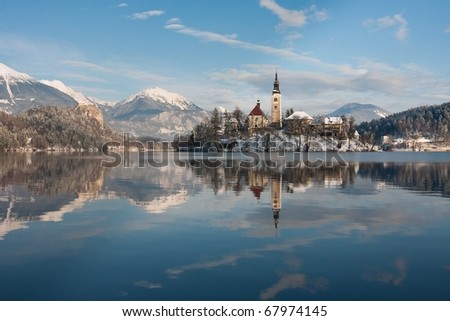 View on lake Bled with small island with church and castle on rock in Slovenia, Europe.