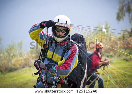 paraglider pilot preparing for lift-off