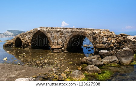 Old bridge in the Ionian Sea. An earthquake in 1953 moved the bridge into the sea.