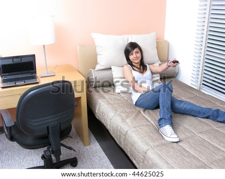 Young watching TV at home and changing channels