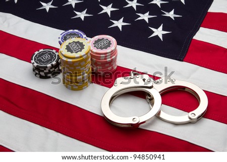A cotton US flag with poker chips and handcuffs