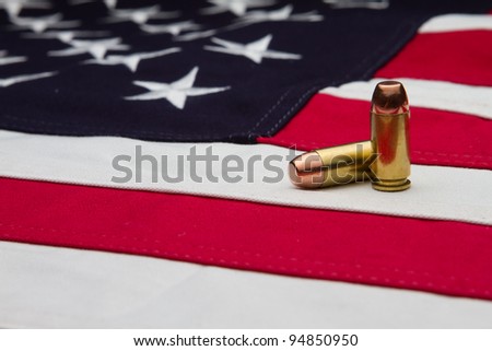 A cotton US flag with a two 40 caliber bullets