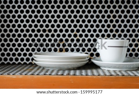 Clean plates and cups on grunge metal Grill Pattern Background