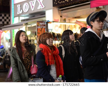 TOKYO, JAPAN - NOV 24 : Crowd at Takeshita street Harajuku on November 24, 2013 in Tokyo, Japan. Takeshita street is a street lined with fashion, cafes and restaurants in Harajuku.