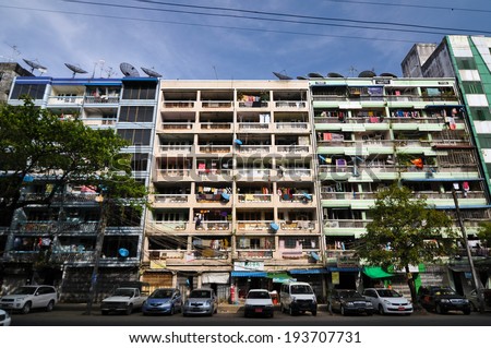 YANGON, MYANMAR - OCTOBER 12, 2013 - Facade of run-down housing block in the Indian quarter on November 12, 2013 in Yangon. The Indian quarter of Yangon is an especially poor area west of the center.