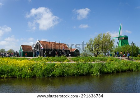 Zaanse Schans, Netherlands - May 5, 2015: Tourist visit Windmills and rural houses in Zaanse Schans, Netherlands. This village is a popular touristic destination in Netherlands