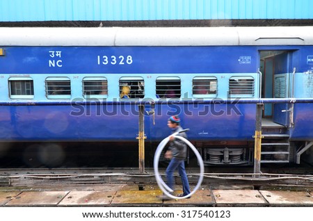 Jaipur, India - January 3, 2015: passengers at the window of a Indian Railway train at the railway station of Jaipur, Rajasthan, India. Indian Railways carries about 7,500 million passengers annually.