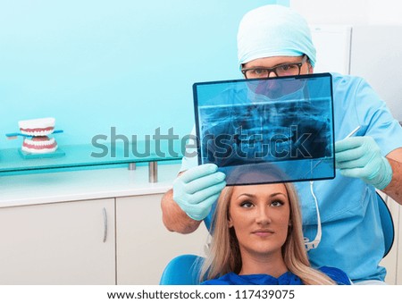 Dentist shows a patient x-ray
