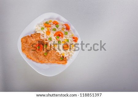Above shot of fried chicken fillet with side dish. Isolated, copyspace
