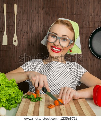 Happy funny woman cook working in the kitchen cutting carrot