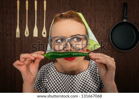 Funny woman cook with hot pepper-close up