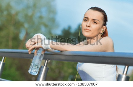 Young sports woman holding drinking water. Sport and leisure