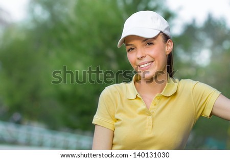 Positive - friendly smiling young sports woman wearing cap, close-up face of fit girl, outdoors