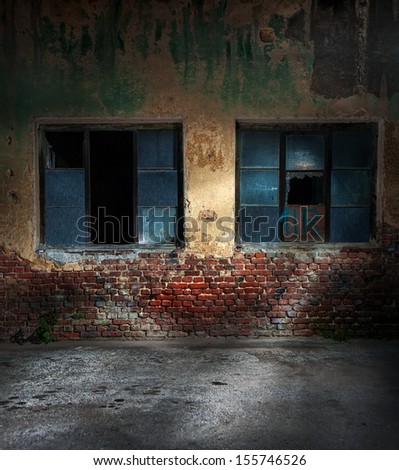 Old cracked or grungy wall and windows at background, night shot