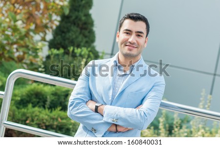 Portrait of gorgeous young man. Happy turkish man, outdoor - outside
