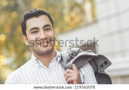 Portrait of gorgeous young smile man. Outdoor - outside. Happy turkish guy