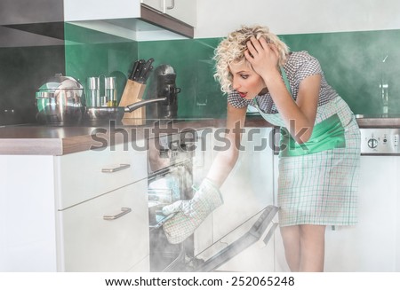 Amazed woman cook frying or roasting something in a oven. Smoke, vapor around in the kitchen or home
