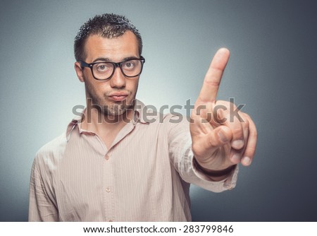 No way. Young man say NO and showing own finger - forefinger, businessman or guy is not statisfied - pleasure, dark gray background. Studio shot