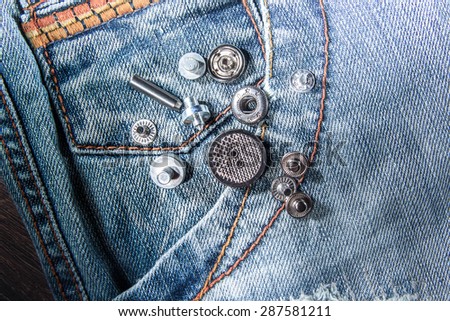 Part of jeans pants with riverts or buttons.Tailor details. Fashion photo, trendy clothes.