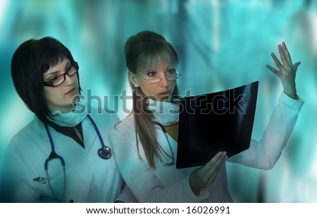 Two happy doctors analyze x-ray