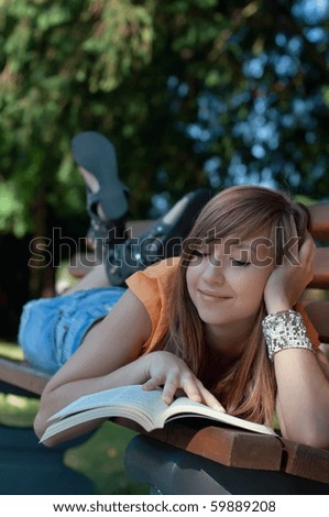 Relaxed girl read book in the park, FOCUS ON FACE
