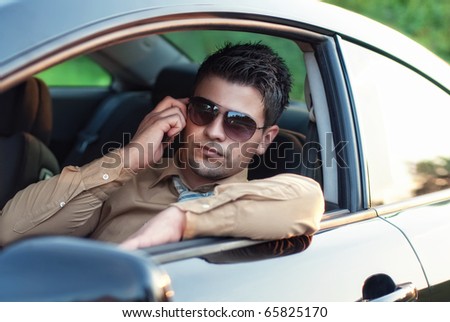 Successfull businessman drive car and call