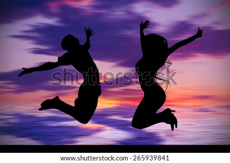 Silhouette of jumping teenagers with sunset sky background