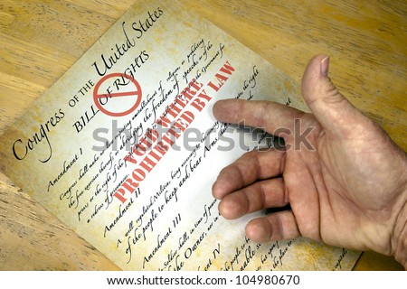 Hand questioning a copy of the United States Bill Of Rights \