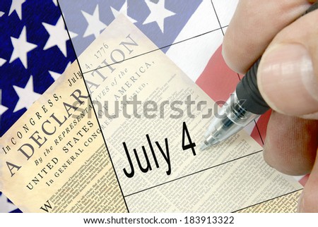 Pen-in-hand calendar notation of United States holiday, Independence Day, Fourth of July, July 4, American flag, floral display, and national cemetery in background.