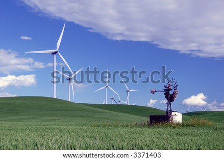 Stark White Electrical Power Generating Wind Turbines on Rolling Wheat Covered Hills, Contrasted by Old Ranch Water Pumping Windmill, Rio Vista, California